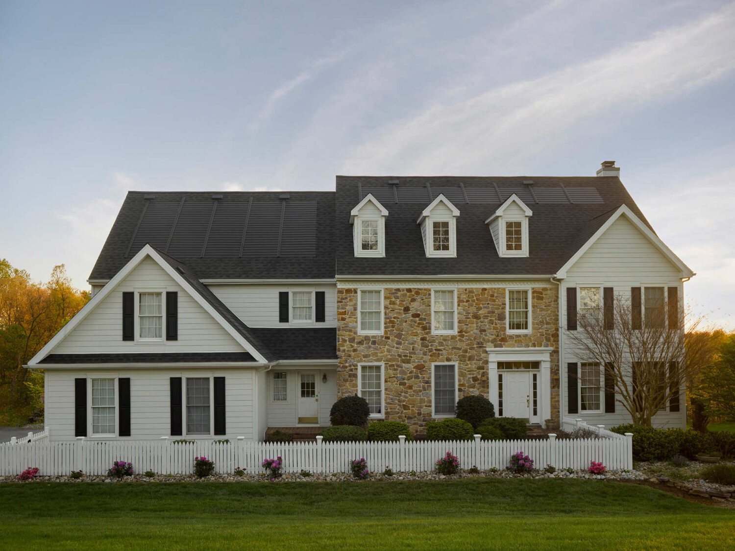 A beautiful residential home featuring solar panels on the roof