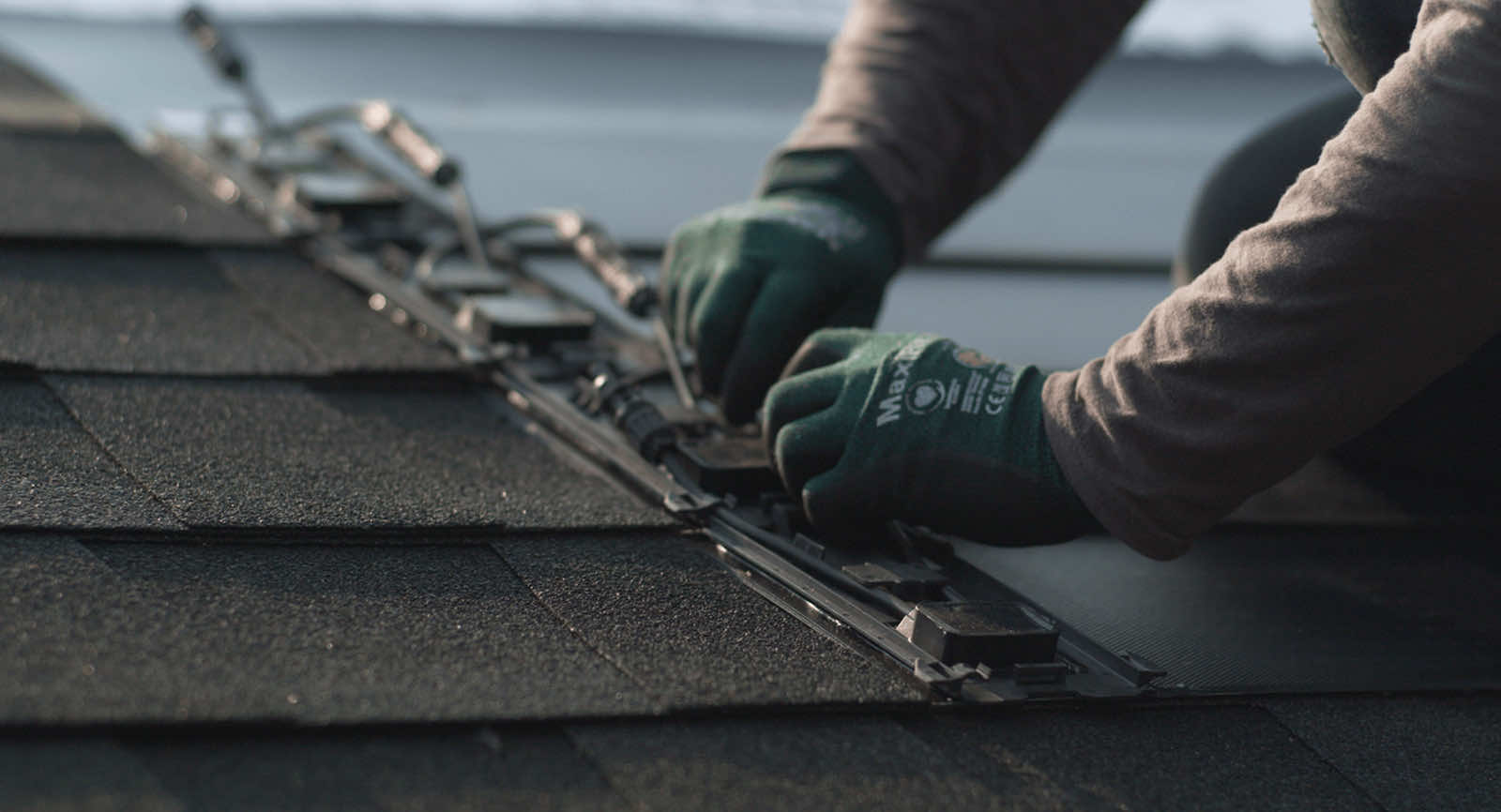 Close-up of a contractor installing roofing materials on a residential roof