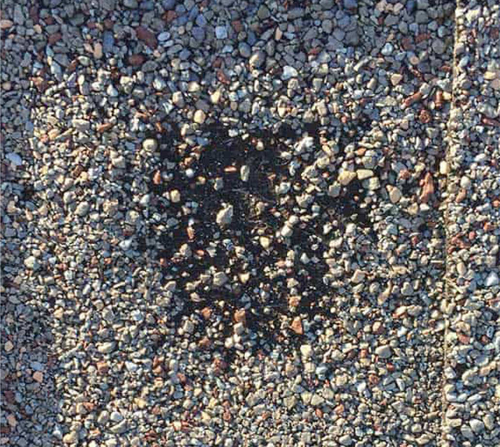 Close-up view of gravel and pebbles on a roofing surface