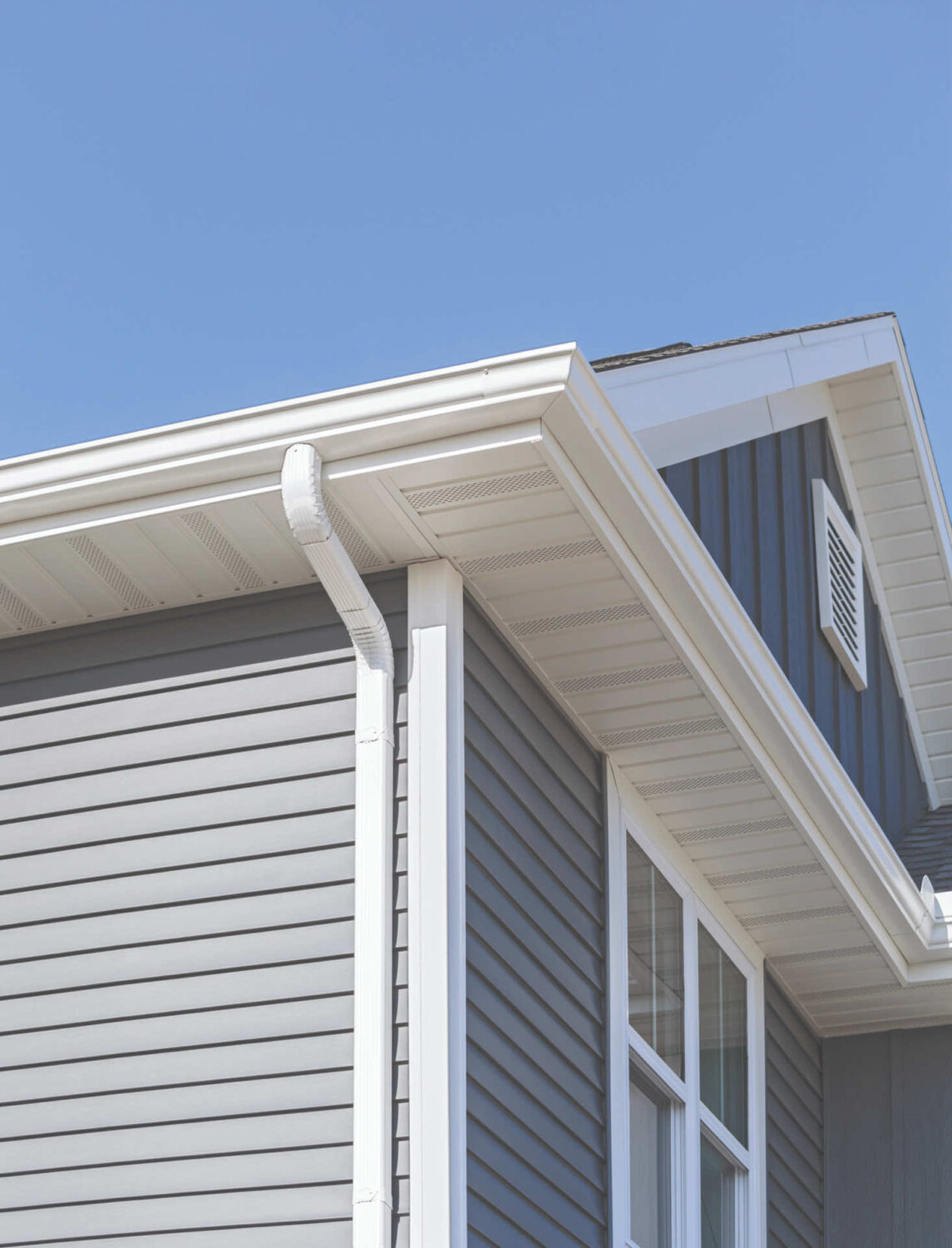 Close-up view of modern home siding and gutter