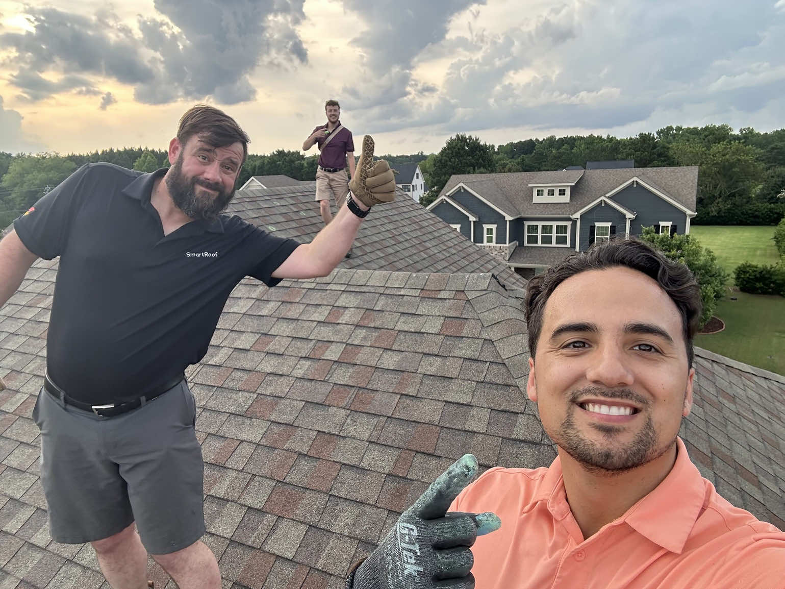 Selfie of SmartRoof team members on a roof during installation