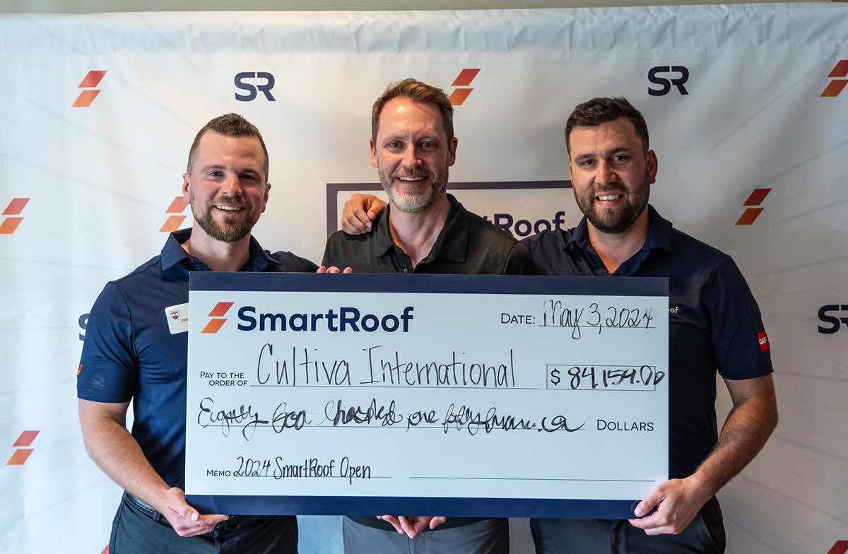 SmartRoof team presenting a check to Cultiva International on May 3