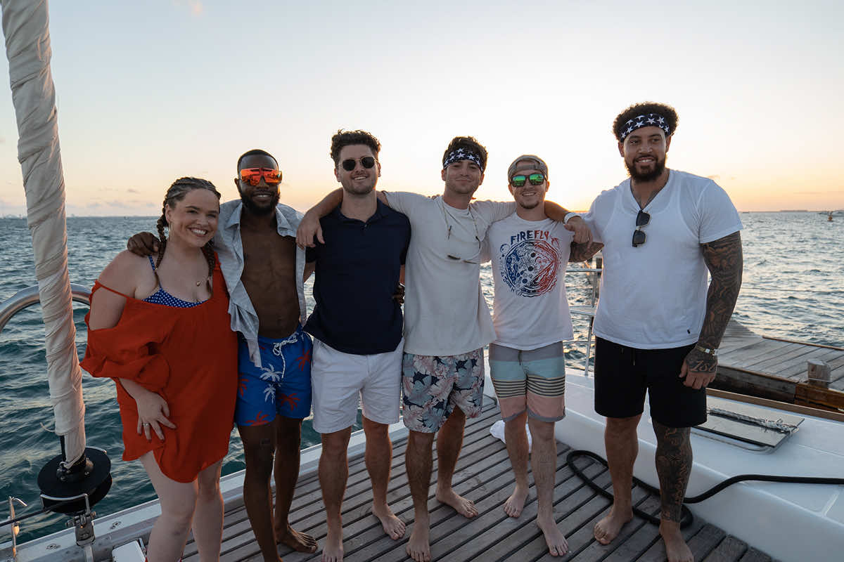 SmartRoof team members on a boat during sunset